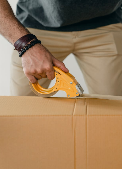 Man sealing box with box tape